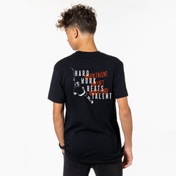 Person wearing a black t-shirt with text and hockey graphics on the back, on a white background