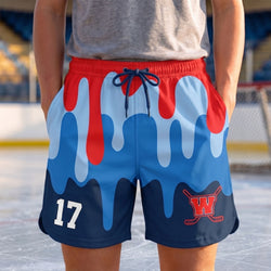 Person wearing blue and red sports shorts with a hockey logo and number on an ice rink.