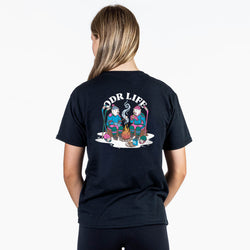 A woman shown from the back wearing a black t-shirt with a colorful graphic of two cartoon characters sitting by a campfire under the text 'ODR LIFE'.