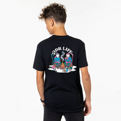 A man wearing a black t-shirt, viewed from the back. The shirt features a large graphic print on the back with the text 'ODR LIFE' and an illustration of two polar bears sitting by a campfire.