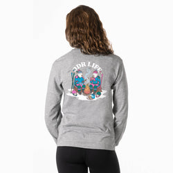 A woman shown from the back wearing a heather gray long-sleeve shirt with a large colorful graphic on the back that reads 'ODR LIFE' and depicts two cartoon figures around a campfire.