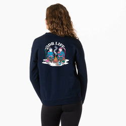 A woman viewed from the back wearing a navy blue sweatshirt with a large colorful hockey graphic and the text 'ODR LIFE' printed across the upper back, paired with black leggings against a plain white studio background.