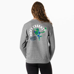 A woman shown from the back wearing a heather gray sweatshirt with a large graphic on the back. The graphic features a hockey player in green and blue with the text 'PUCKY CHARMS' in white.