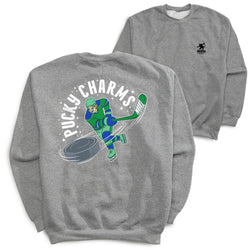Two heather gray crewneck sweatshirts shown on a white background, with the front and back views overlapping. The back sweatshirt features a large graphic of a hockey player in green and blue with the text 'PUCKY CHARMS' arched above.