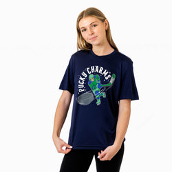A young woman modeling a navy blue short-sleeve graphic t-shirt with a green and white 'Pucky Charms' hockey player design on the front, set against a plain white background.