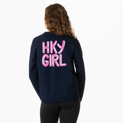 A girl viewed from behind wearing a navy blue sweatshirt with 'HKY GIRL' printed in pink bubble letters across the back, paired with black leggings, against a plain white background.