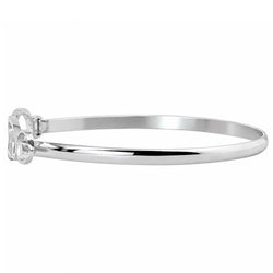 A polished silver-tone metal bangle bracelet with a decorative openwork end piece, shown against a plain white background.