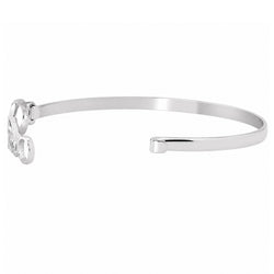A polished silver-tone metal cuff bracelet with a small decorative script detail on one end, shown against a plain white background.