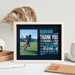Dear Dad Girls Lacrosse wooden frame featuring a picture of a girl playing lacrosse sitting on a desk