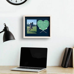 Dear Mom Girls Lacrosse wooden frame featuring a picture of a girl playing lacrosse hanging on a wall above a computer