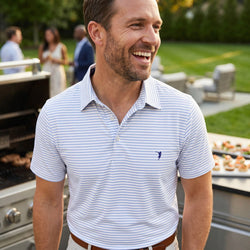 Man wearing a lacrosse polo shirt outdoors at a bbq.