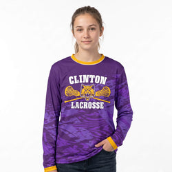 Person wearing a purple lacrosse long-sleeve shirt with a custom logo on a white background