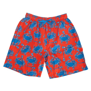 Red swim trunks with blue crab pattern on a white background