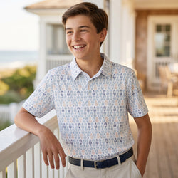 Boy wearing a white lacrosse patterned polo shirt
