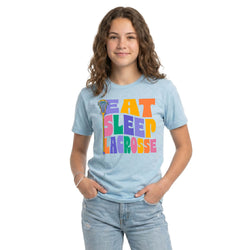 Person wearing a light blue t-shirt with colorful text 'Eat Sleep Lacrosse' on a white background