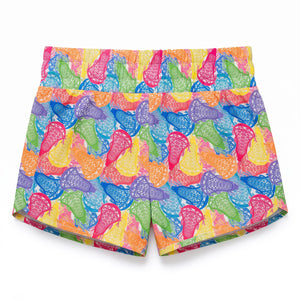 A pair of women's athletic shorts featuring a vibrant, multicolor pattern of stylized lacrosse sticks in pink, blue, green, orange, and purple on a bright yellow background.