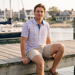 Person wearing a patriotic themed polo shirt with lacrosse patterned design.