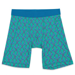 Flat lay of green lacrosse themed compression shorts with crossed sticks pattern