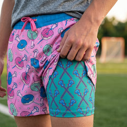 Person wearing colorful shorts with patterns on a grassy field