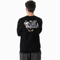 Person wearing a black t-shirt with a bigfoot inspired 'Play Like a Beast' graphic on the back.