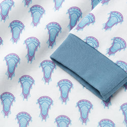 A folded white fabric garment or textile with a repeating pattern of light blue and purple lacrosse head motifs, shown with a ribbed blue cuff on a white background.