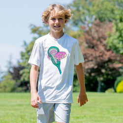 Young boy wearing a white t-shirt with a colorful lacrosse stick with donut design outdoors on a sunny day.