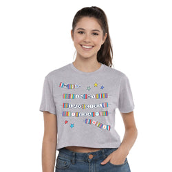Person wearing a gray t-shirt with colorful text and graphics on a white background