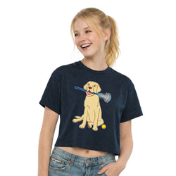 Girl wearing a navy blue t-shirt with a dog graphic holding a lacrosse stick and ball on a white background
