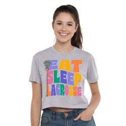 Woman wearing a gray t-shirt with 'Eat Sleep Lacrosse' in colorful letters on a white background