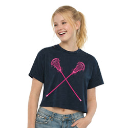 Girl wearing a navy blue t-shirt with pink lacrosse sticks design on a white background