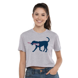Woman wearing a gray t-shirt with a graphic of a dog and a lacrosse stick on a white background