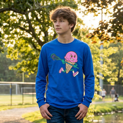 Person wearing a blue long-sleeve shirt with a pink ice cream cone graphic holding a lacrosse stick outdoors.