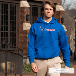 Person wearing a royal blue hoodie with patriotic lacrosse text in front of a brick building