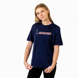 Girl wearing a navy tech tee with a patriotic lacrosse design