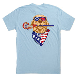 Light blue t-shirt with a graphic of a dog wearing sunglasses and an American flag bandana, holding a lacrosse stick.