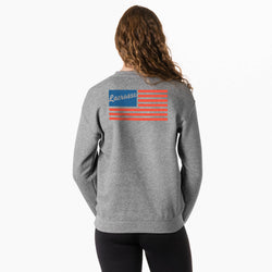 Person wearing a gray sweatshirt with a lacrosse usa flag graphic on the back against a white background