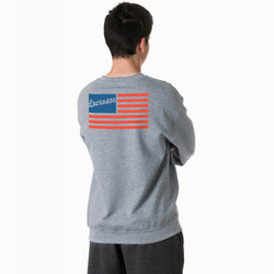 Person wearing a gray sweatshirt with a lacrosse-themed usa flag design on the back against a white background