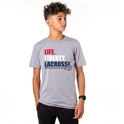 Person wearing a gray short sleeve tee with Life Liberty Lacrosse patriotic design