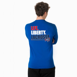 Person wearing a blue shirt with 'LIFE. LIBERTY. LACROSSE' text on the back, on a white background