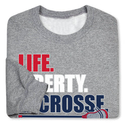 Gray sweatshirt with 'LIFE. LIBERTY. LACROSSE' text and graphics on a white background