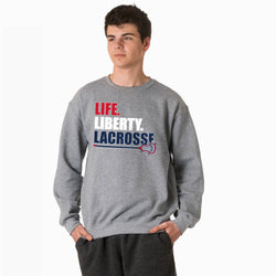 Person wearing a gray sweatshirt with 'LIFE. LIBERTY. LACROSSE' text on a white background