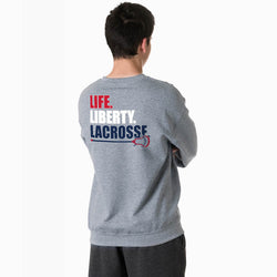 Person wearing a gray sweatshirt with 'LIFE. LIBERTY. LACROSSE' text on the back.
