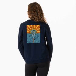 Person wearing a navy blue sweatshirt with a colorful sunset lacrosse graphic on the back against a white background