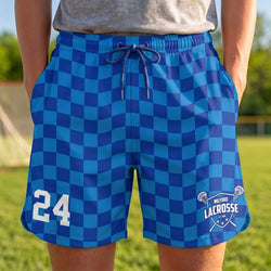 Blue checkered shorts with number 24 and 'Milford Lacrosse' logo on a grassy field background