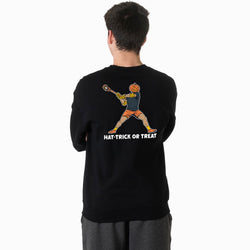 A youth viewed from behind wearing a black crewneck sweatshirt with a graphic of a person doing a hat-trick lacrosse move with a pumpkin head and the text 'HAT-TRICK OR TREAT' printed below.