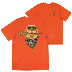 Bright orange short-sleeve t-shirt shown from both front and back. The front features a small embroidered bearded dog logo on the left chest, and the back displays a large graphic of a dog wearing sunglasses and a camouflage bandana, holding a lacrosse stick.