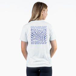 Person wearing a white t-shirt with a graphic design on the back, featuring 'No Days Off' text and crossed lacrosse sticks.