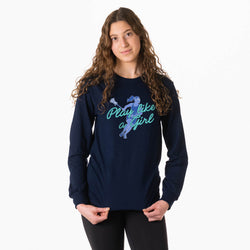 A woman with long, wavy brown hair models a navy blue long-sleeve t-shirt featuring a graphic of a gymnast in blue and the text 'Play like a girl' in teal, set against a plain white background.