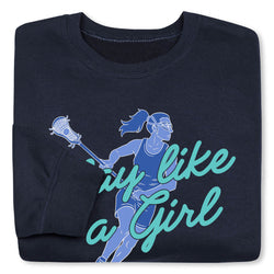 A folded navy blue crewneck sweatshirt featuring a graphic of a lacrosse player in blue and teal text that reads 'Play like a girl'.