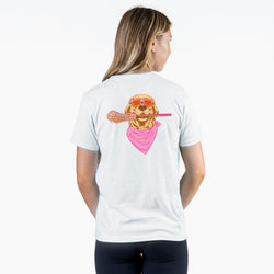 Girl wearing a white short sleeve tee with a esign on the back of a dog wearing pink sunglasses, a bandana, and holding a lacrosse stick on a white background.